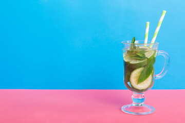 Mojito summer refreshing cocktail with ice and mint. mojito cocktail with lime, lemon and mint in a tall glass with a stick