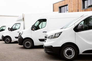 Several cars vans trucks parked in parking lot for rent delivery white vans in service van truck...