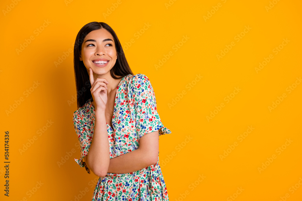 Wall mural Photo of lovely girly female look blank space daydreaming thinking wear flowery dress isolated on yellow color background