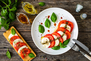 Caprese salad on wooden table
