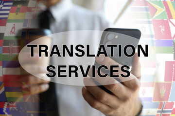 Translation services. Man holding smartphone indoors, closeup