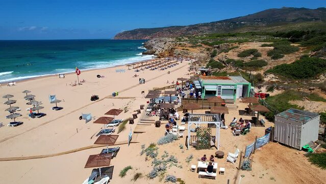Aerial view from Guincho beach where we can see also people at a beach bar. Guincho,Cascais,Portugal