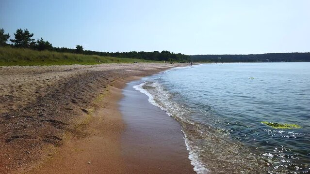 Wide view of beach and water line on sunny summer day, Gotland, Sweden