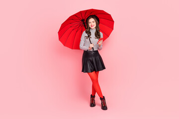 Photo of charming stylish trendy lady hold parasol rainy weather use smart device chat isolated...