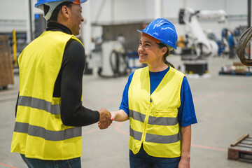Engineer workers shaking hands inside robotic factory - Focus on senior woman face