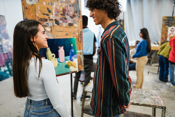 Young students painting inside art room class at university - Focus on girl face