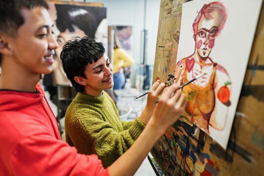 Multiracial students painting inside art room class - Focus on girl face
