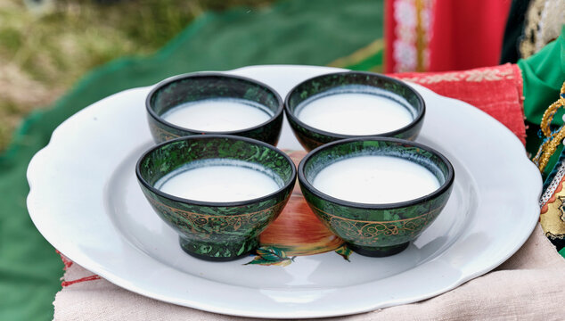 Four bowls with traditional Bashkir pattern, filled with mare's milk or koumiss, national drink