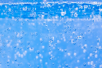 Water bubbles texture on blue background. Abstract background, selective focus, close up image.