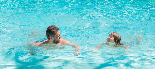 Father and son in swimming pool, banner with copy space. summer holidays weekend at family day. dad...