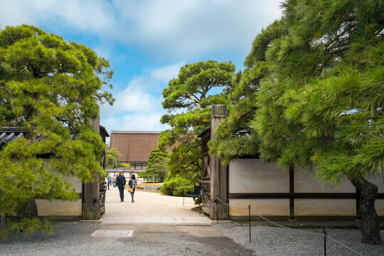 People walk into a Gate to the Imperial Palace area - An important historic landmark in Kyoto, Japan.