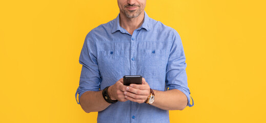 smiling man chatting on phone on yellow background, chat