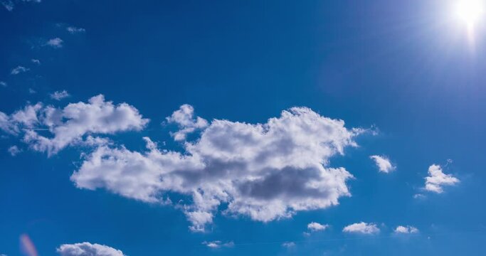 blue sky with clouds and airplane condensation trail timelapse