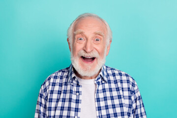 Portrait of cheerful overjoyed grandpa see sale coupon advertisement wear checkered shirt isolated on teal color background