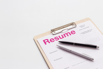 Searhing for a new job. Resume application form on office table