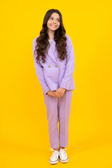 Obraz premium Full length photo of pretty teenager child girl wear casual clothes isolated on yellow background. Happy teenager, positive and smiling emotions of teen girl.