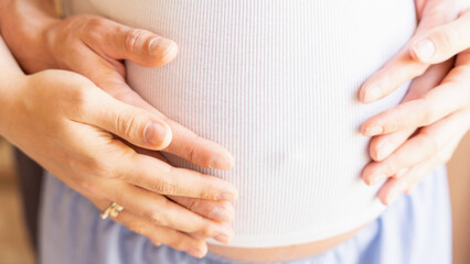 Belly hands pregnant woman. Happy pregnancy woman and husband hugging pregnant belly. Concept of pregnancy, maternity, expectation for baby birth.