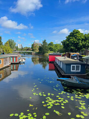 Fototapeta premium Beautiful view of canal with floating houses and boat