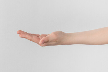 child hand palm up. side view Isolated on a white anf gray background close-up, copy space