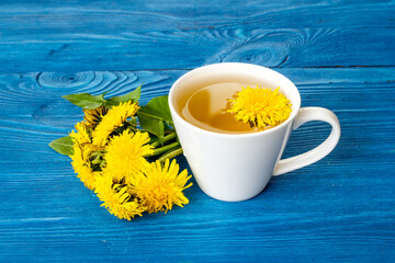 Herbal tea with meadow healing herbs - yellow dandelions blossoms and leaves