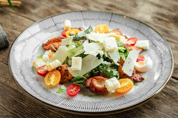 Closeup on gourmet chicken salad with parmesan on wooden background