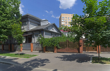 Wooden log house in a modern city. Chernyshevsky Lane, Moscow, Russia.