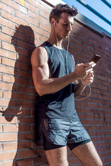 Male runner man taking a break from running training.