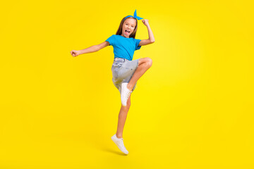 Fototapeta na wymiar Full body portrait of overjoyed delighted person jump raise fists celebrate success isolated on yellow color background