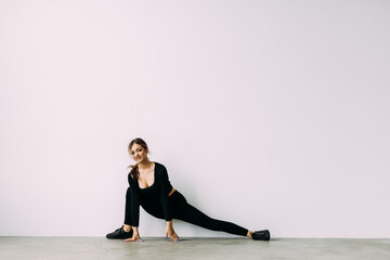 Fitness woman doing stretching workout. Young woman on white background. Stretching and motivation