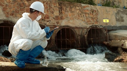 Ecologists sample water contaminated with dangerous, waterhazard toxins into tubes, Scientist or...