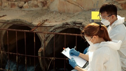 Ecologists sample water contaminated with dangerous, waterhazard toxins into tubes, Scientist or...