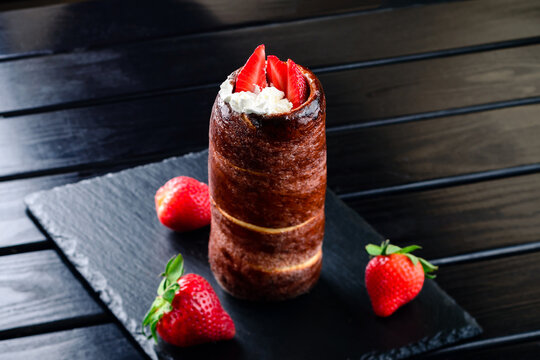 Trdelnik is a traditional Czech dessert. Trdlo bun with whipped cream and strawberries