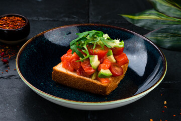 Open sandwiches with salted salmon, guacamole avocado and microgreens. Seafood. Healthy food. Top view.