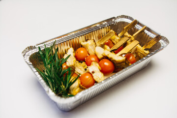 Chicken kebab with tomatoes on a white background