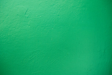 Green concrete wall background. Grunge green plaster wall.