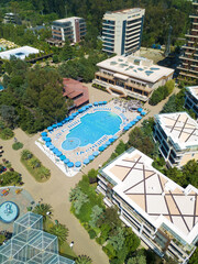 Fototapeta na wymiar Beautiful view from the drone to the pool, the hotel grounds on a sunny day. Vertical photo