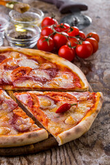 Pizza with tomatoes, sausage and hot peppers