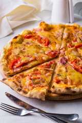 Pizza with cheese, prosciutto and ham