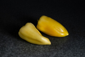 Fresh yellow peppers heap on the kitchen table. Preparation for cooking.