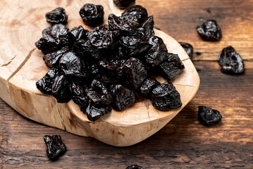Dried prunes on a wooden background. Dry fruits.