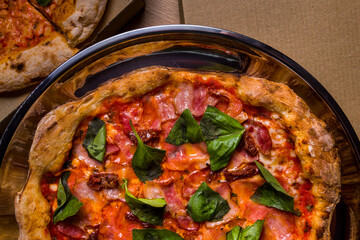 Pizza with prosciutto cheese, basil, bacon, pepper and sauce