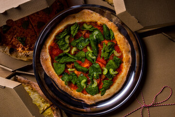 Pizza with basil, spinach, asparagus peppers, tomatoes and sauce