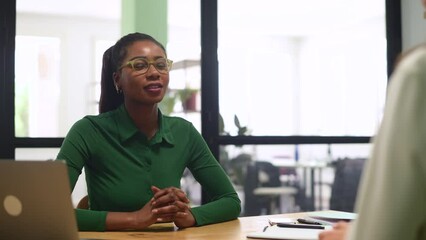 Business women shaking hands in the office during business meeting. Two diverse female entrepreneurs on meeting in boardroom. Female recruiter and employee confirm hiring