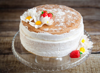Decorated cake with mastic strawberries and flowers