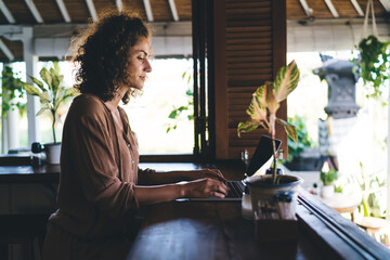 Millennial IT professional keeping digital nomad and freelance lifestyle using laptop computer for...