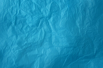 Obraz premium Wrinkled or creased colorful cyan blue tone solid color on wrap paper texture background with creative modern style and space