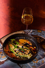 Fried salad with parsley, pepper, caviar, nuts and sauce