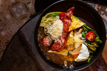 Salad with fried meat, fried chicken cutlet, boiled egg, tomatoes, parmesan