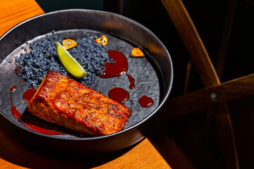 Grilled salmon steak with lemon, blue salt and sauce