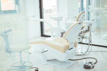 A clean modern well equipped dental surgery prepped and ready to take the first patient of the day . Horizontal color image of modern dental office with equipment.